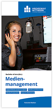 Eine junge Frau steht an einem Mikrofon in einem Radio Studio.